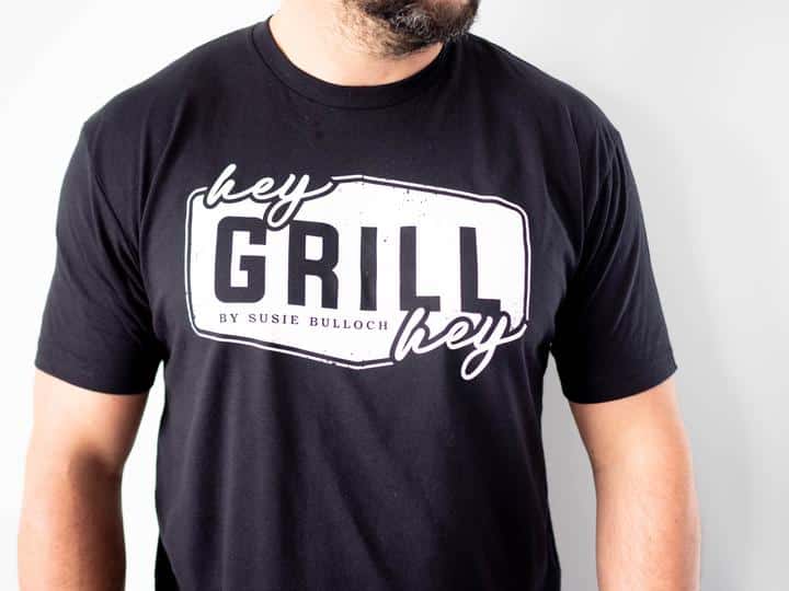 torso of a man wearing a black hey grill hey logo t-shirt