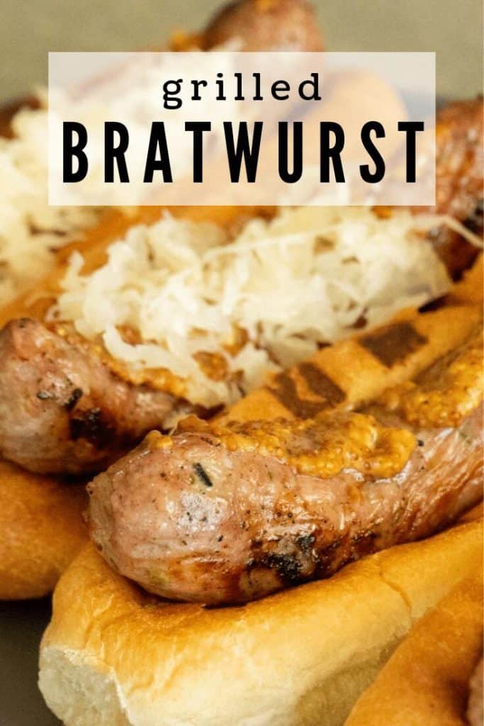 Grilled bratwurst in a bratwurst bun topped with mustard and sauerkraut.