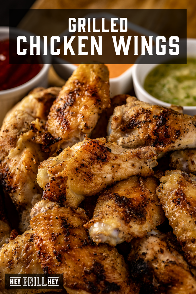 Pile of grilled chicken wings with text overlay - Grilled Chicken Wings.