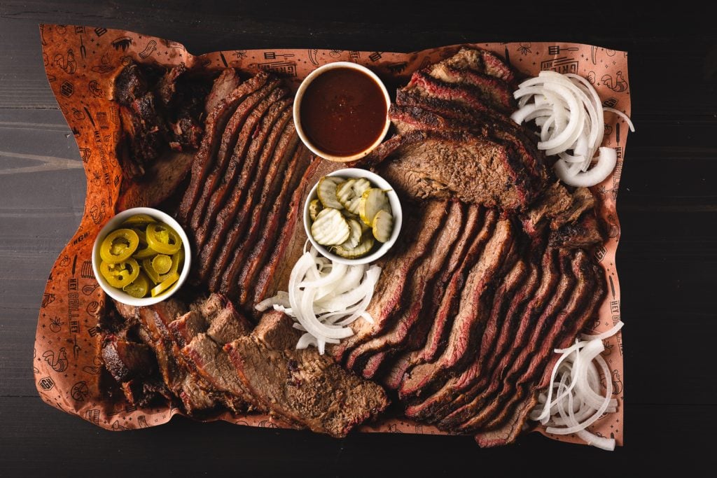 Smoked brisket on a platter with all the fixings.