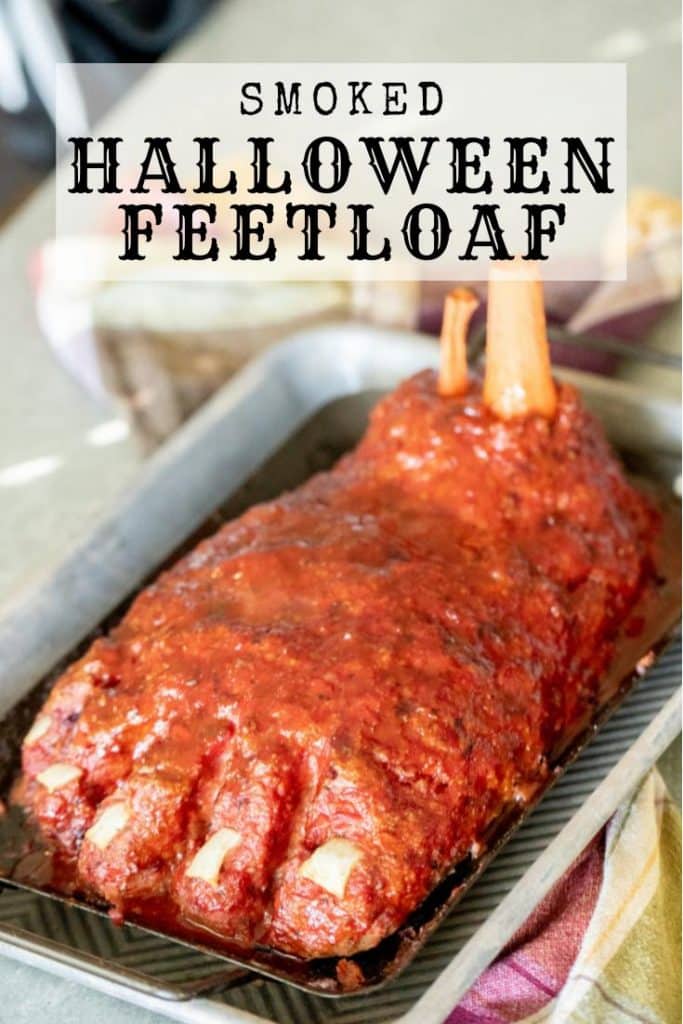 Meatloaf shaped like a large foot, on a baking sheet. Text overlay reads, "Smoked Halloween Feetloaf."