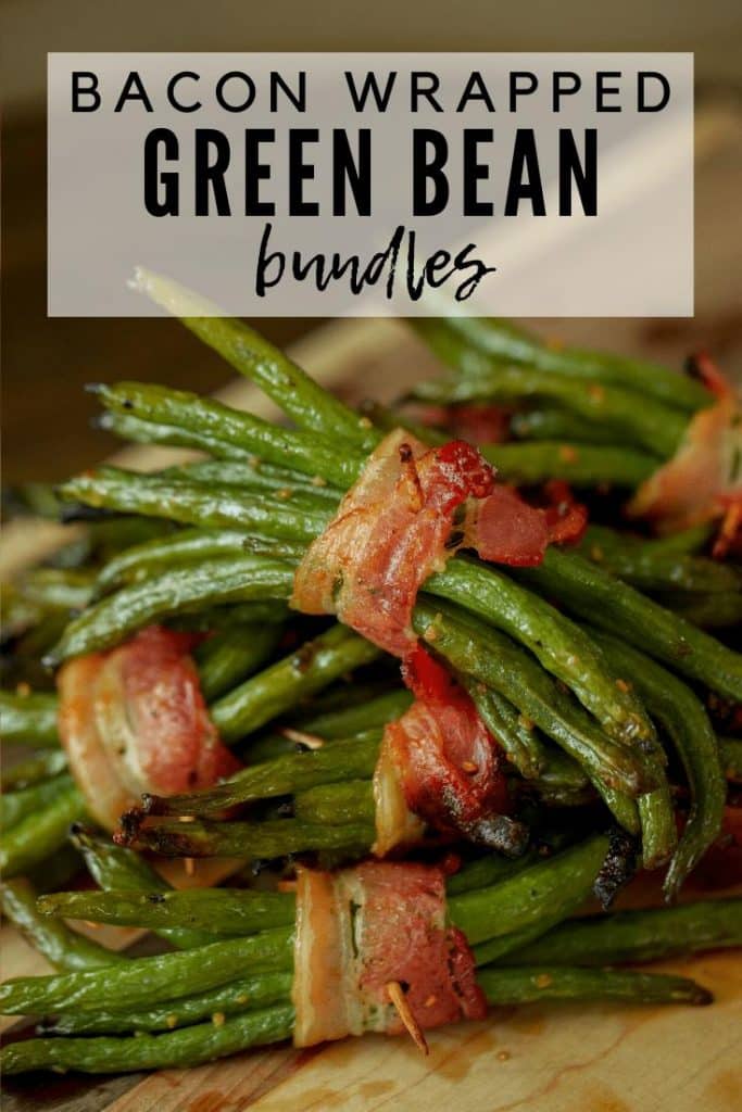 Bacon Wrapped Green Bean Bundles in a stack on a wooden cutting board