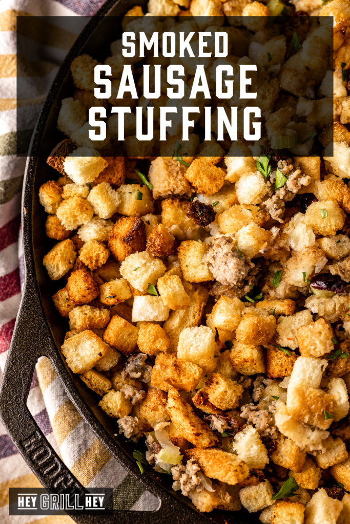Smoked stuffing in a cast iron skillet with text overlay - Smoked Sausage Stuffing.