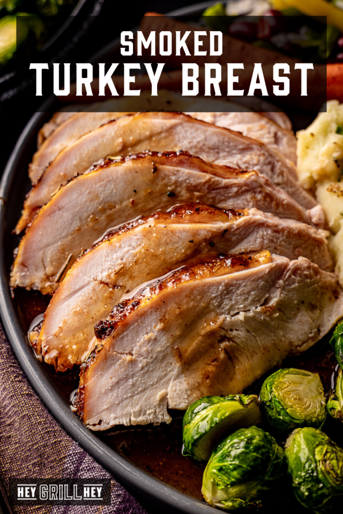 Sliced turkey breast on a plate next to brussels sprouts and mashed potatoes with text overlay - Smoked Turkey Breast.