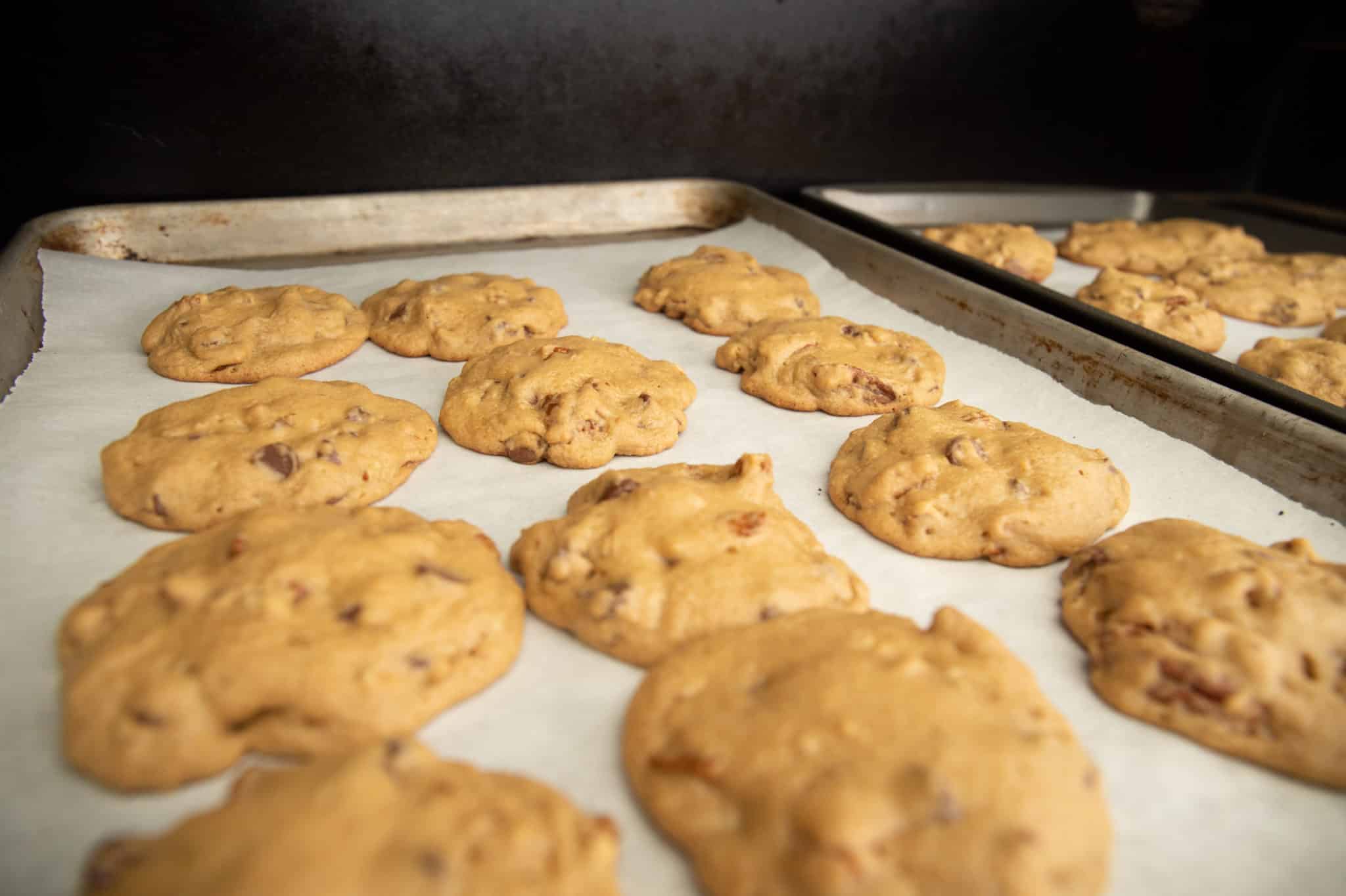 two trays of smoked chocolate chip cookies in the smoker.