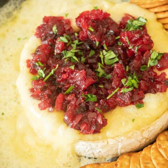Grilled brie cheese wheel topped with cranberry jalapeno relish.