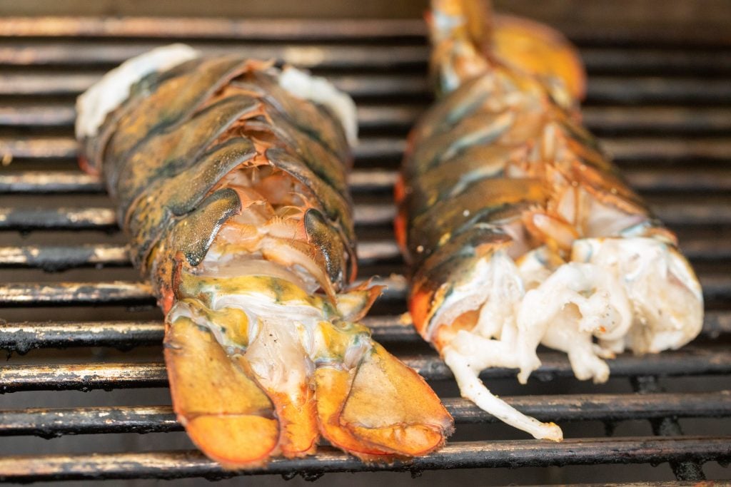 two lobster tails on the grill.
