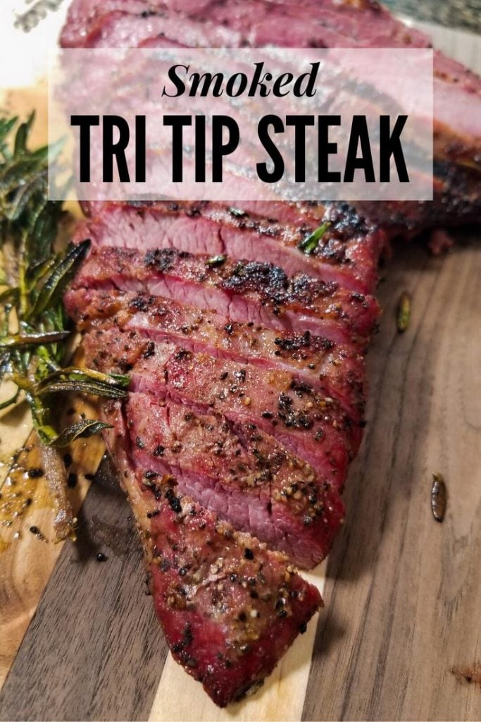 smoked tri tip steak on a wooden cutting board