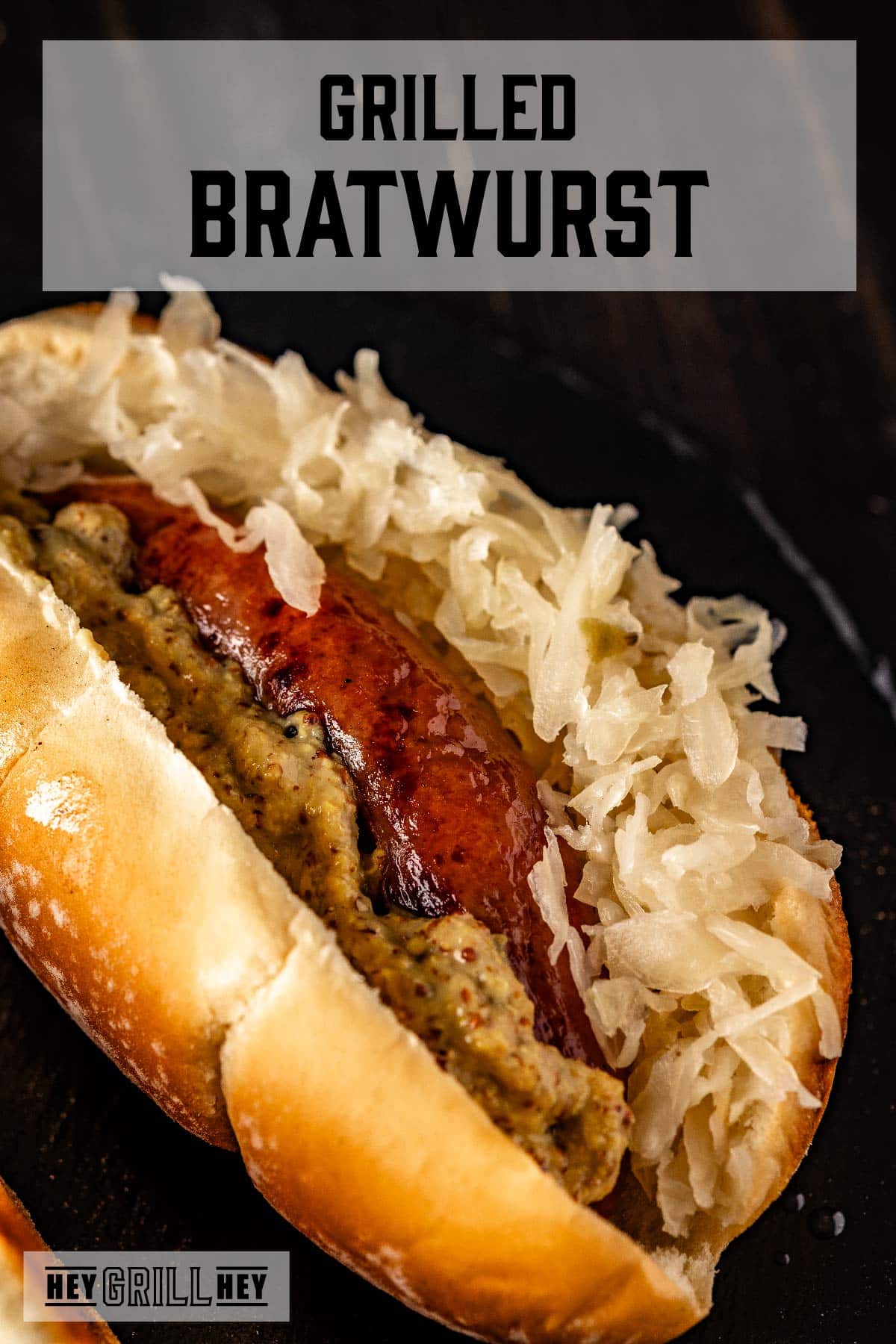 Grilled brat on a bun with sauerkraut and mustard. Text reads "Grilled Bratwurst."