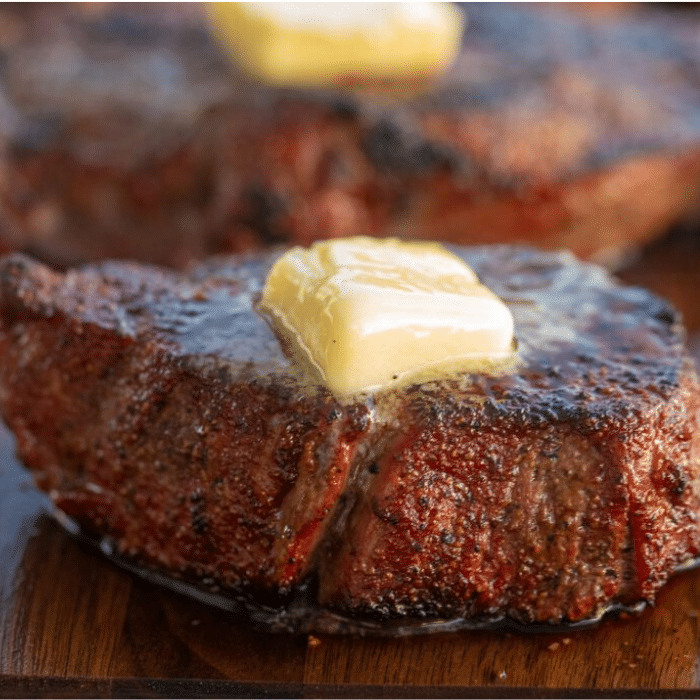 grilled steak topped with a cube of melting butter. 