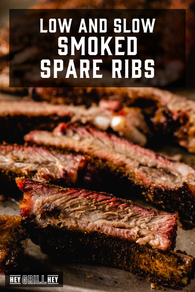 Smoke spare ribs sliced on a cutting board with text overlay - Low and Slow Smoked Spare Ribs.