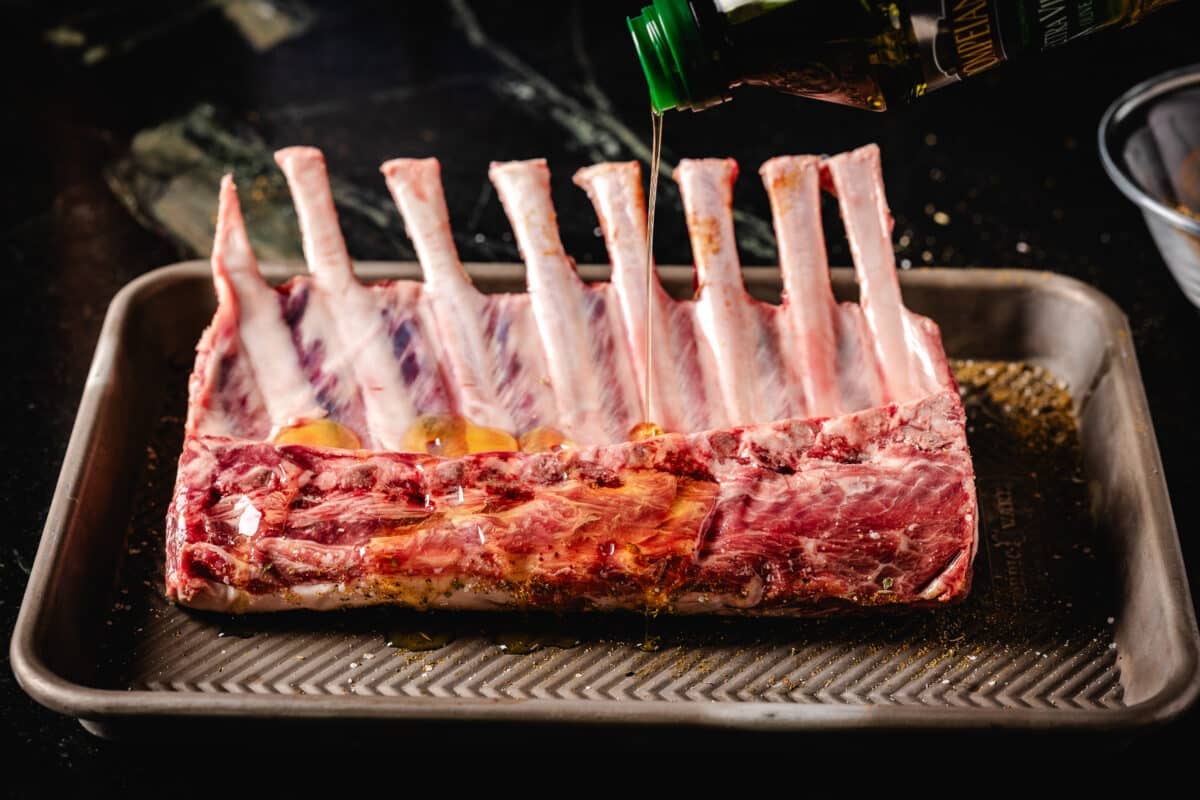 Raw lamb on a baking sheet.