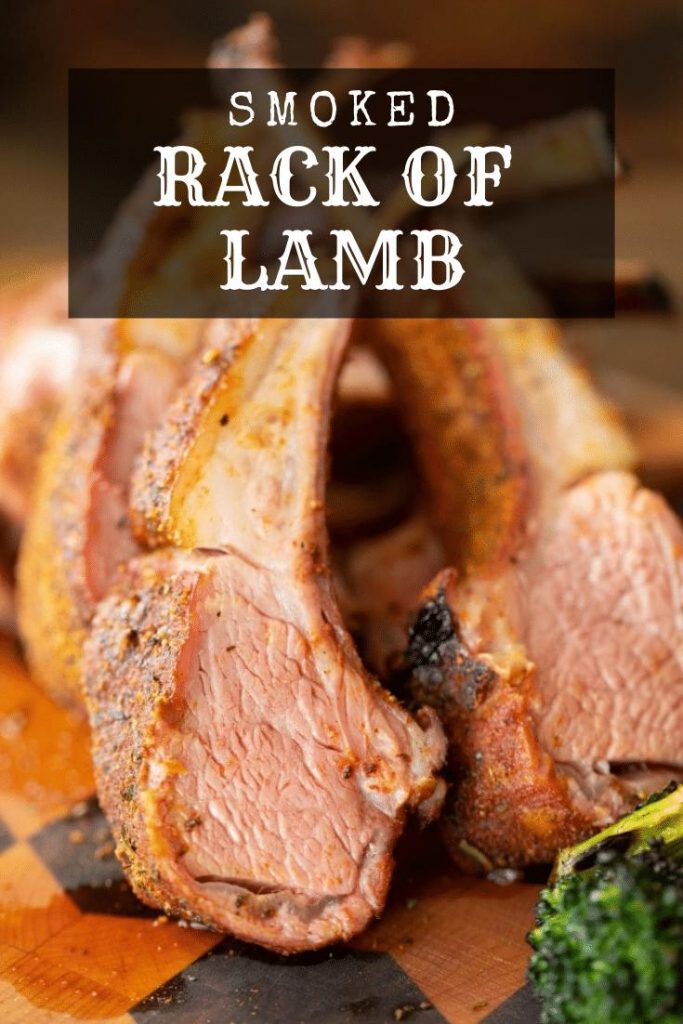 Finished sliced rack of lamb stacked on a wood cutting board. Text Overlay: Smoked Rack of Lamb.