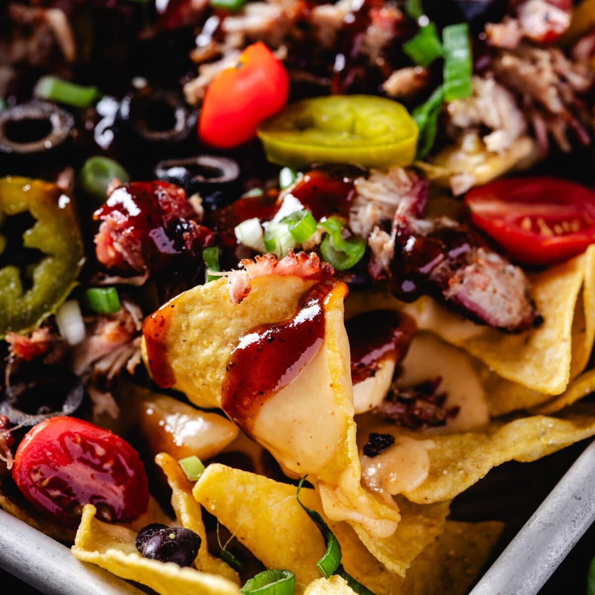 A closeup shot of a tray of loaded nachos.