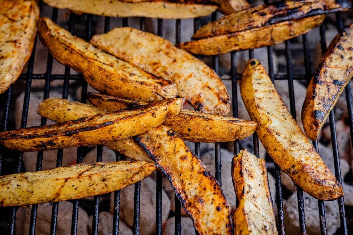 Potato slices on grill grates.