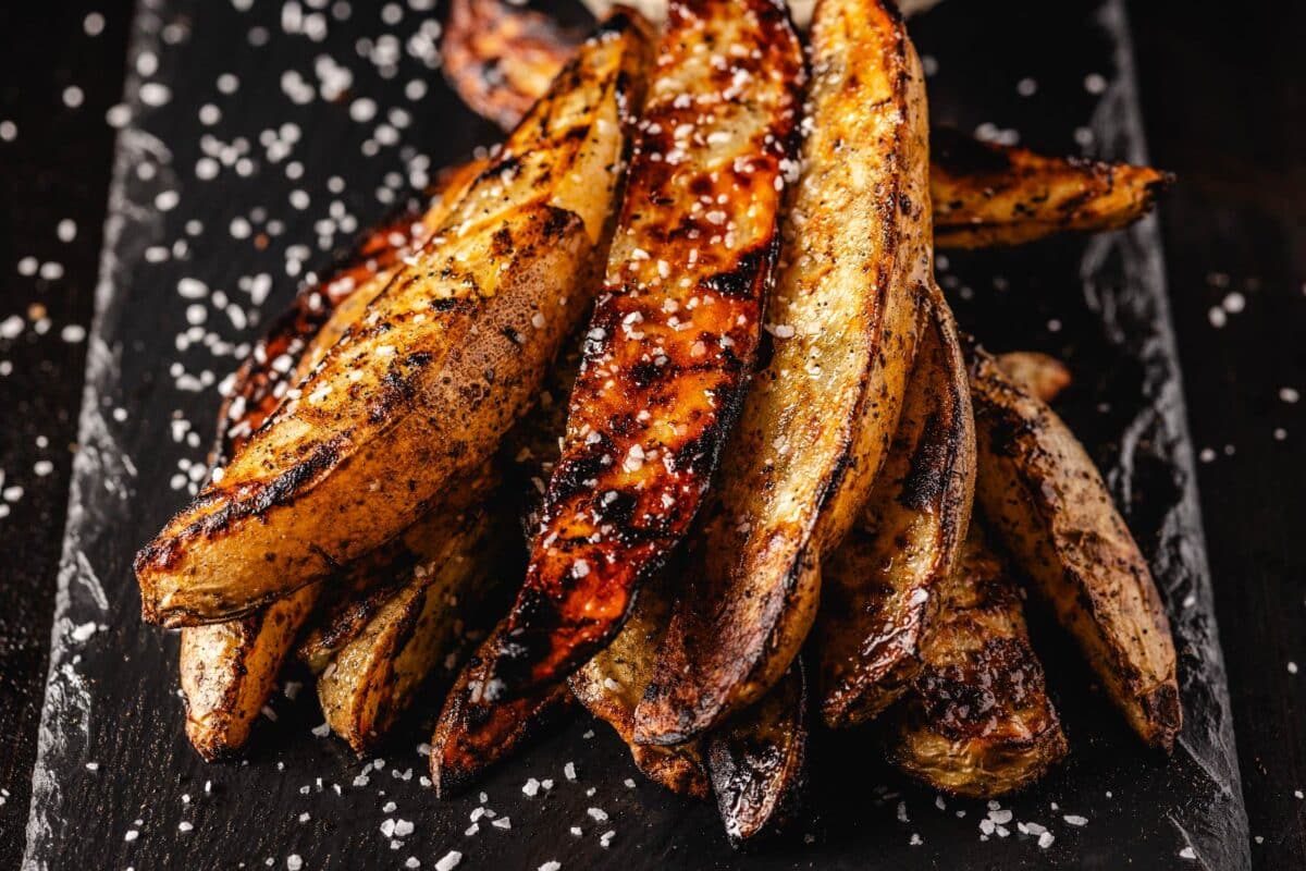 Potato wedges on serving platter sprinkled with salt.