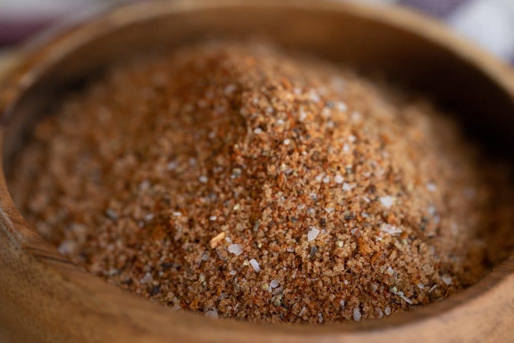Close up of mesquite seasoning blend in a wooden bowl.