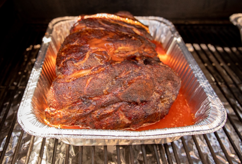 pork shoulder in an aluminum pan.