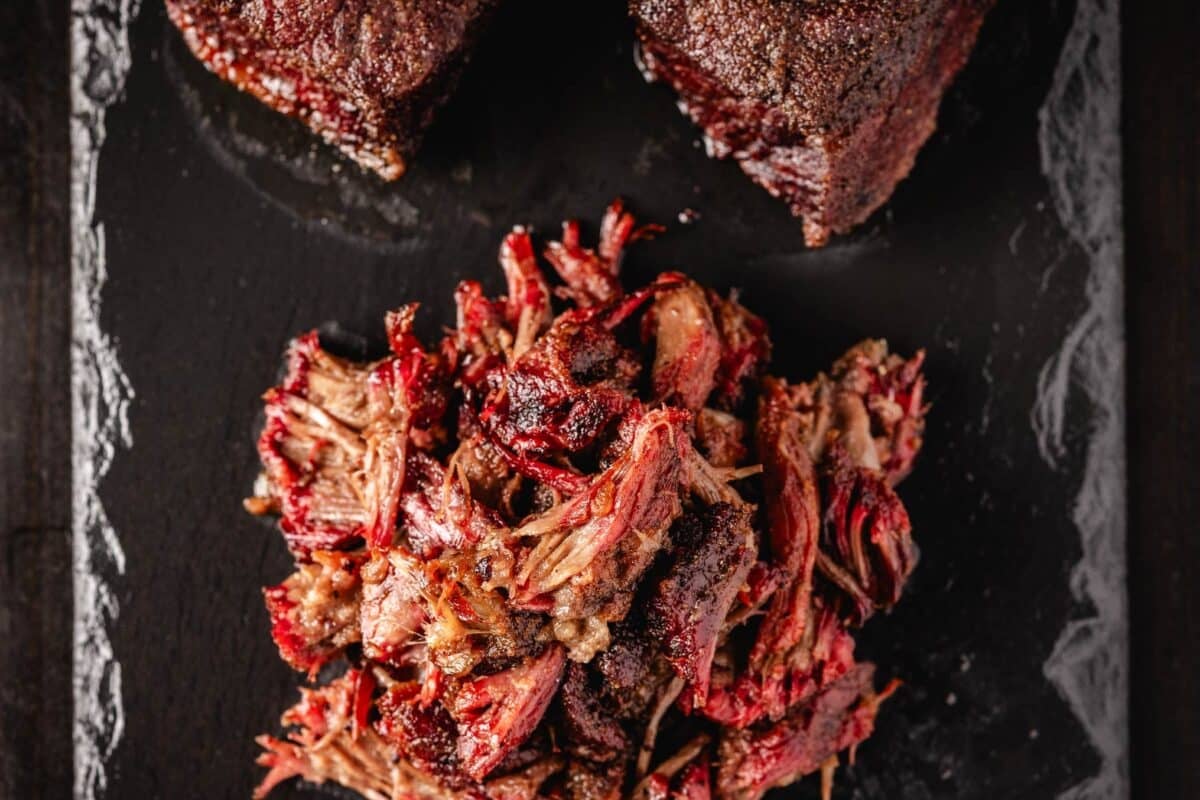 Shredded and un-shredded beef on serving platter.