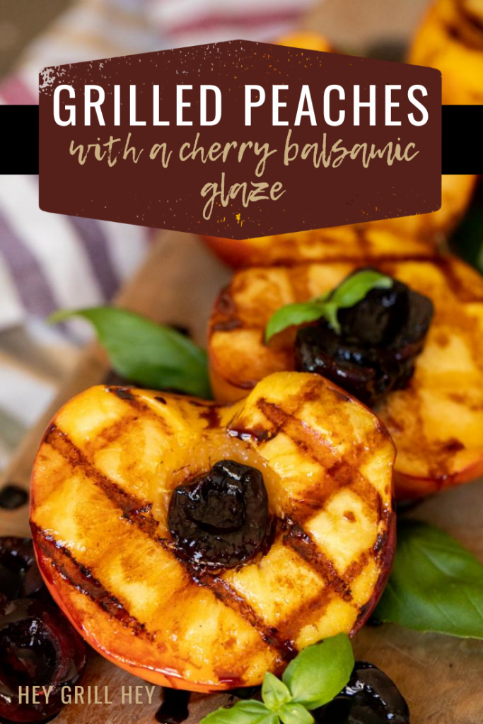 Grilled peaches will grill marks topped with glazed cherries and garnished with mint.