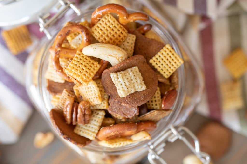 Overhead shot of smoked Chex mix in a hinged glass mason jar.