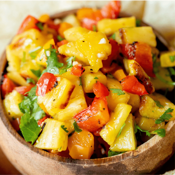Grilled pineapple salsa in a wooden bowl.