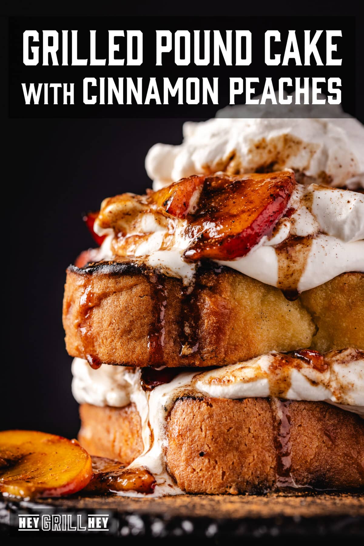 Pound cake with cream and peaches on a black plate. The text overlay reads "Grilled Pound Cake with Cinnamon Peaches" at the top, and "Hey Grill Hey" at the bottom.