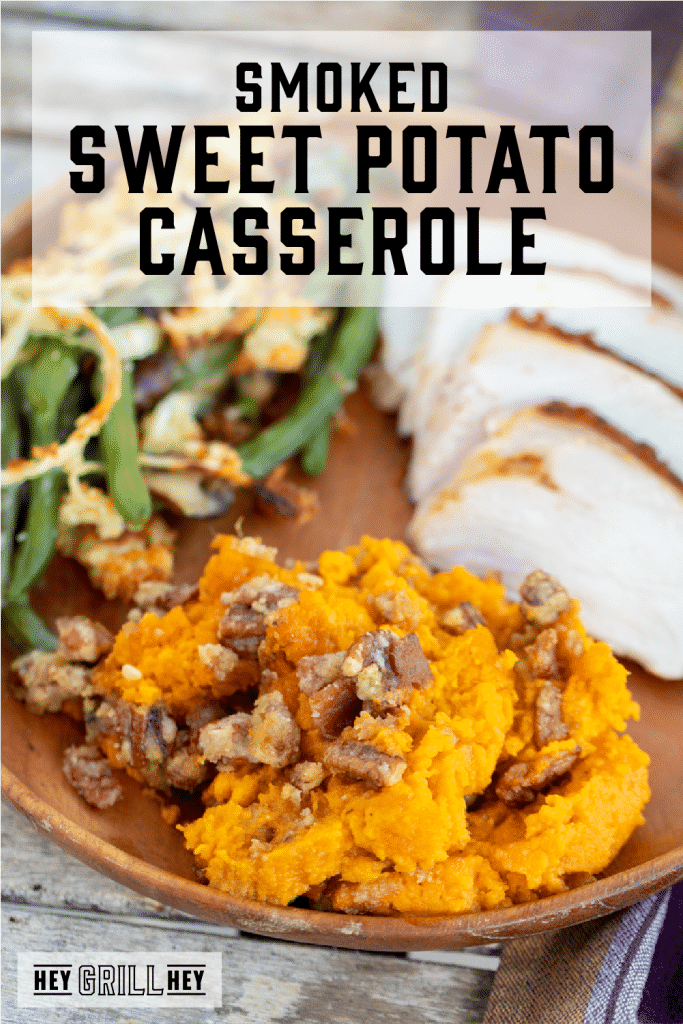 Smoked sweet potato casserole on a plate with sliced turkey and green beans with text overlay - Smoked Sweet Potato Casserole.