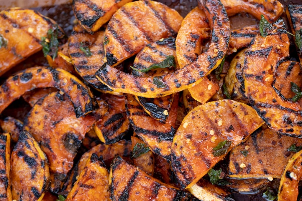 Grilled butternut squash slices in a pile.
