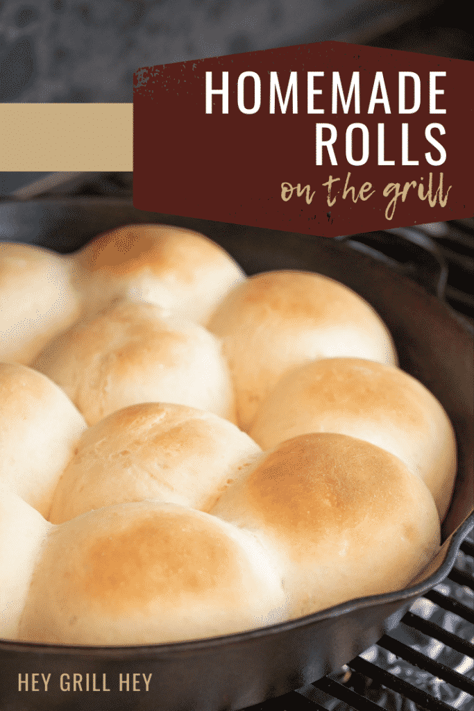 Golden brown rolls in a cast iron skillet on the grill grates of a smoker. Text overlay reads: Homemade Rolls on the Grill.