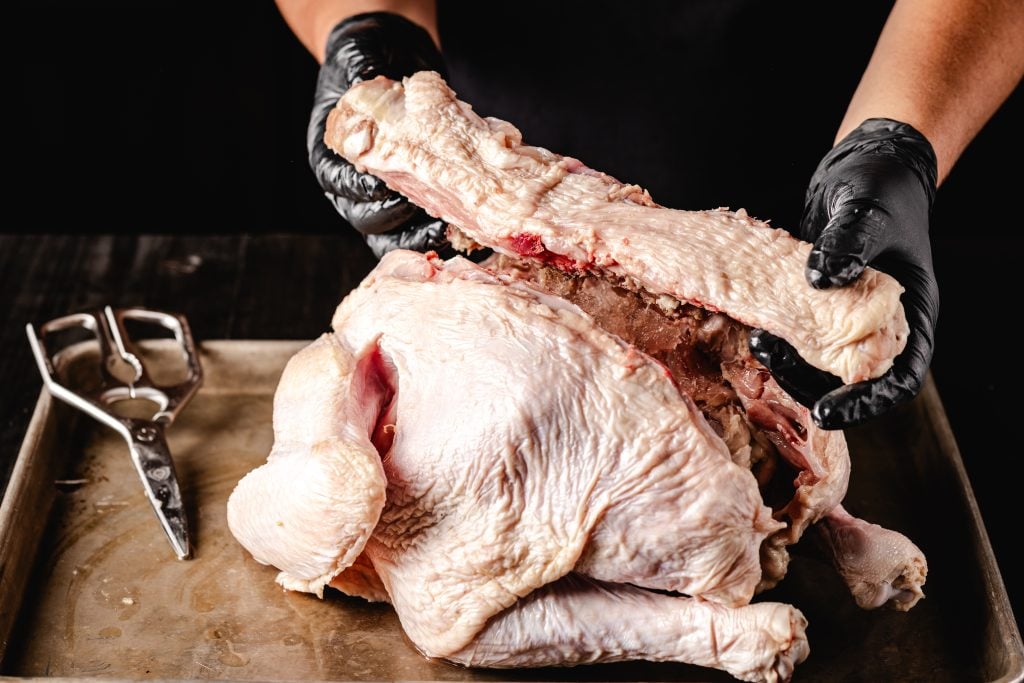 Backbone being removed from a turkey.