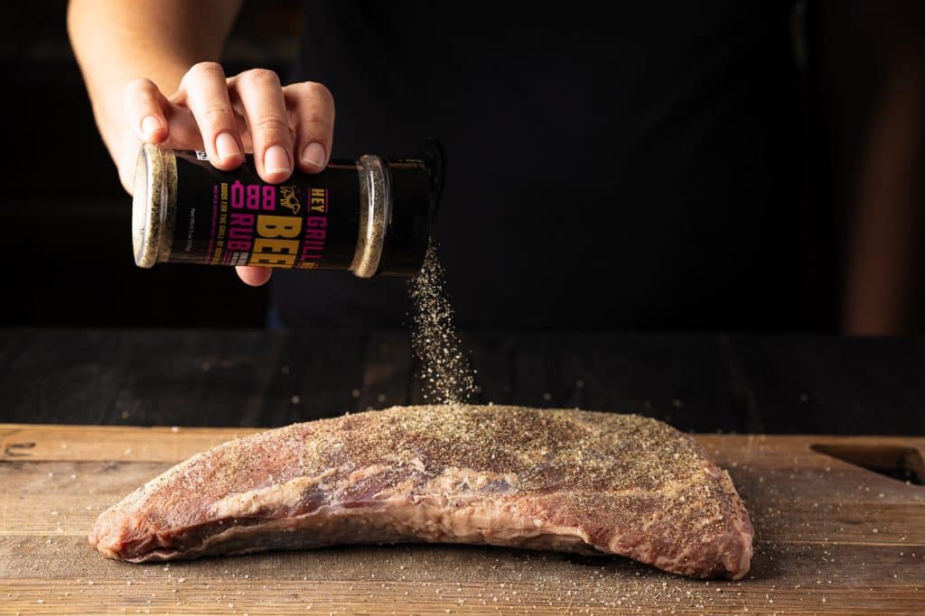 Hey Grill Hey Beef Rub being sprinkled on a tri tip.
