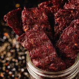 Ground beef jerky strips in a glass jar.