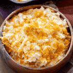 Smoked funeral potatoes in a wooden bowl.