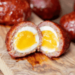 Cross-section of a sliced smoked scotch egg.