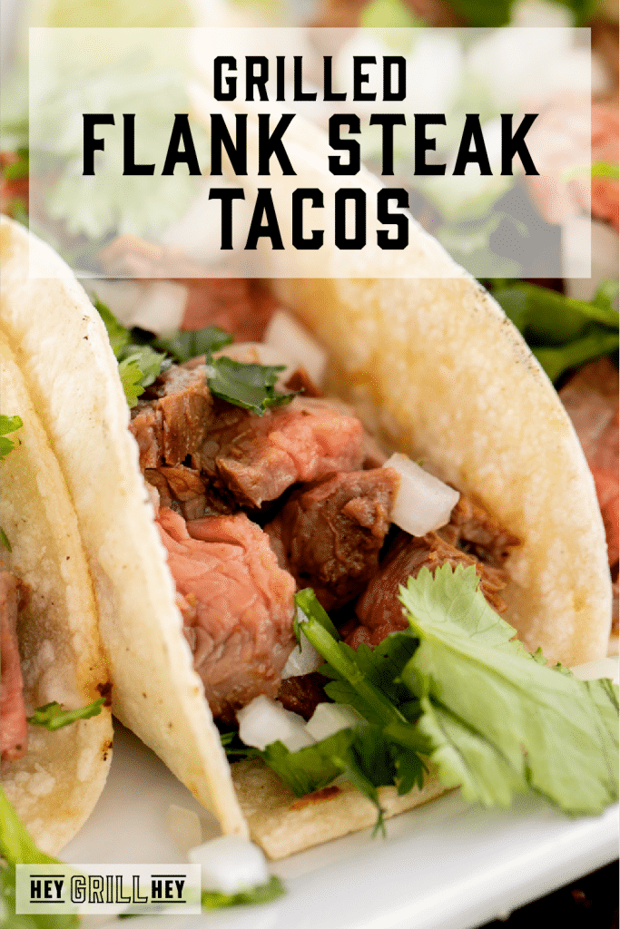 Flank steak taco on a white plate with text overlay - Grilled Flank Tacos.