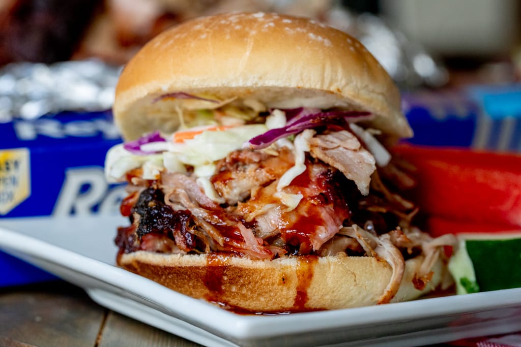 BBQ pulled pork sandwich on a plate.