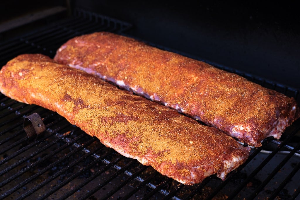 Seasoned Asian style baby back ribs on the grill.