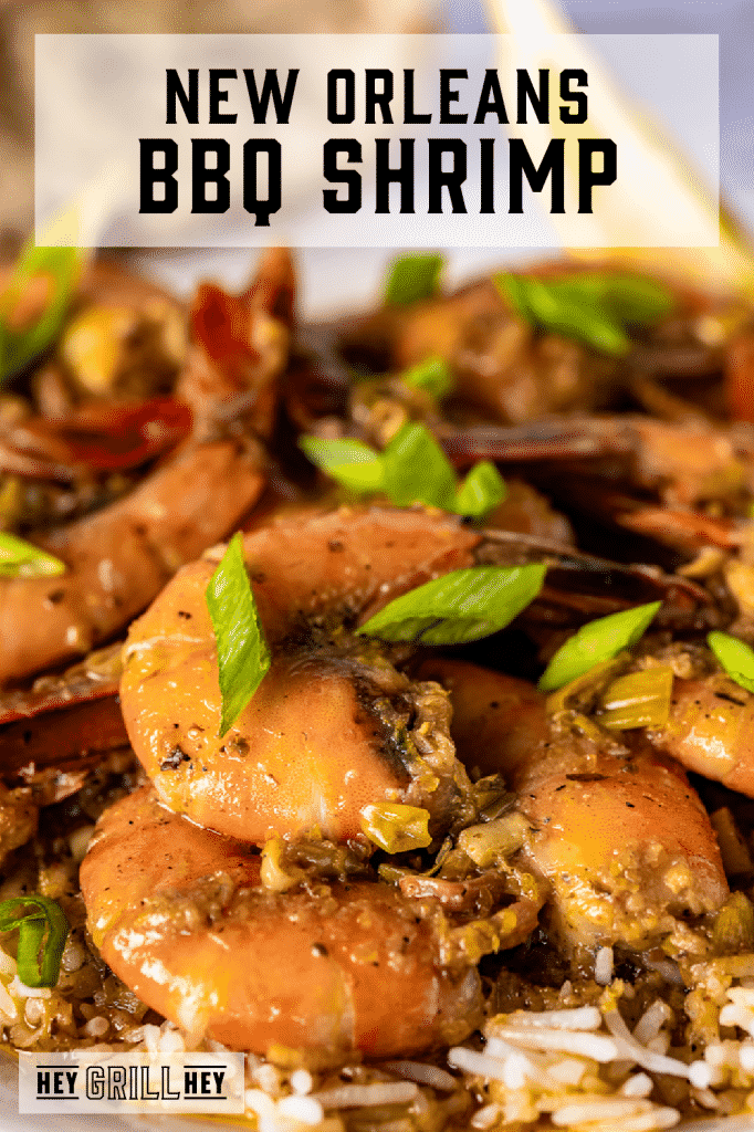 BBQ shrimp garnished with green onions with text overlay - New Orleans BBQ Shrimp.
