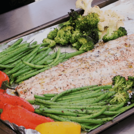 Grilled salmon and vegetables on a sheet pan.