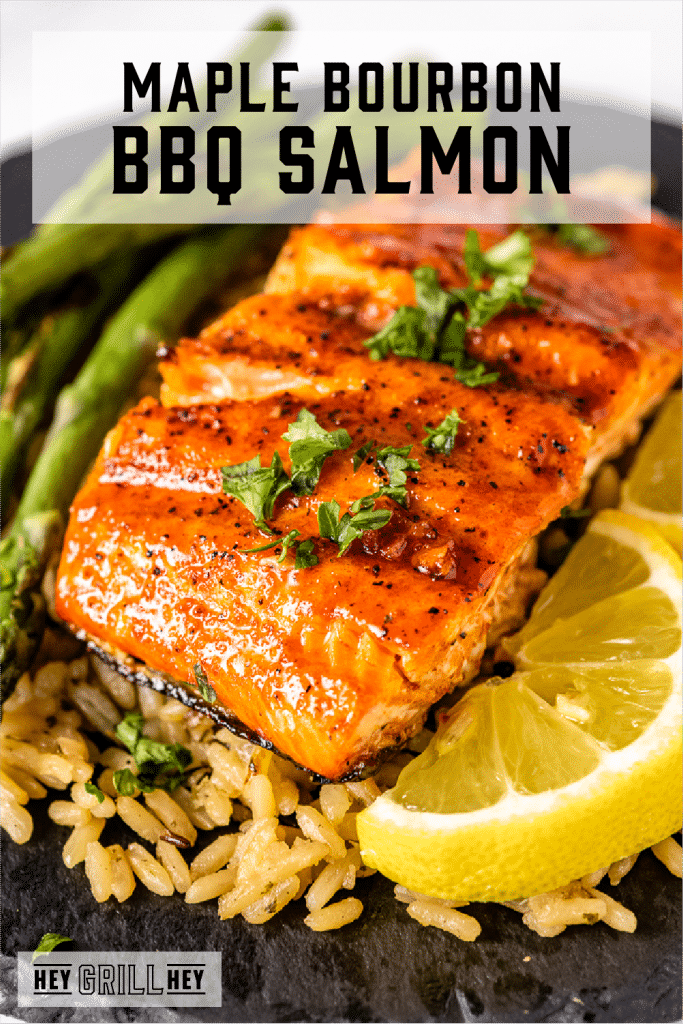 BBQ salmon on a bed of rice next to grilled asparagus with text overlay - Maple Bourbon BBQ Salmon.