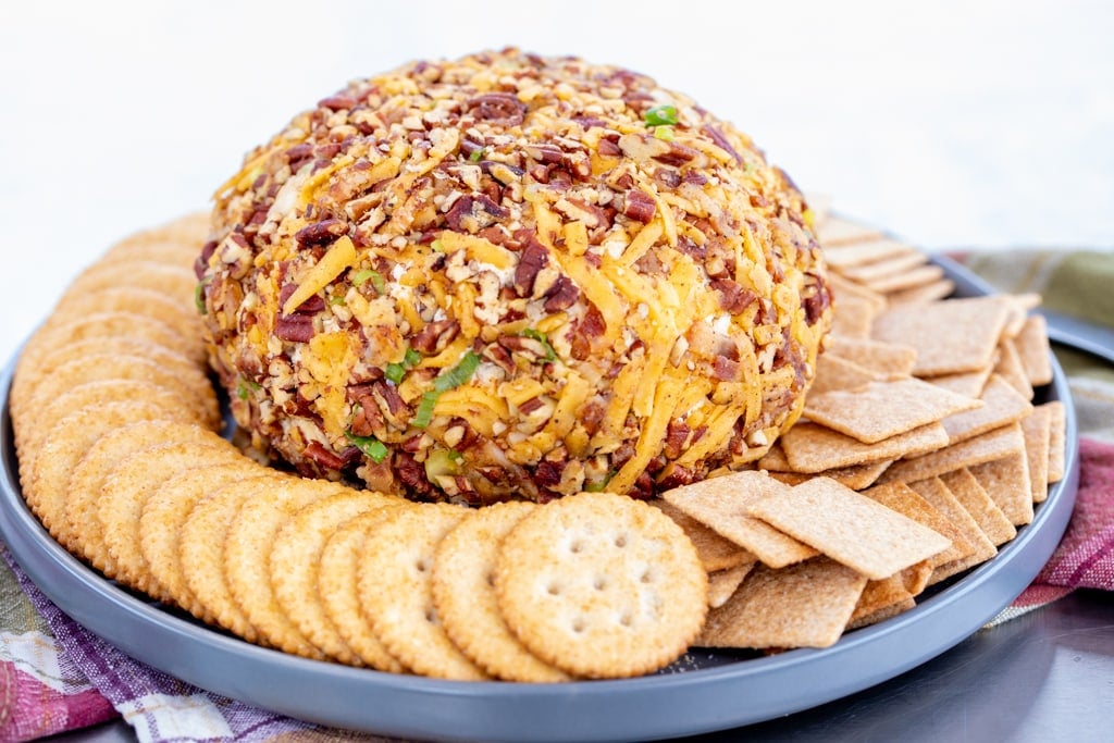 Smoked cream cheese ball surrounded by various crackers.