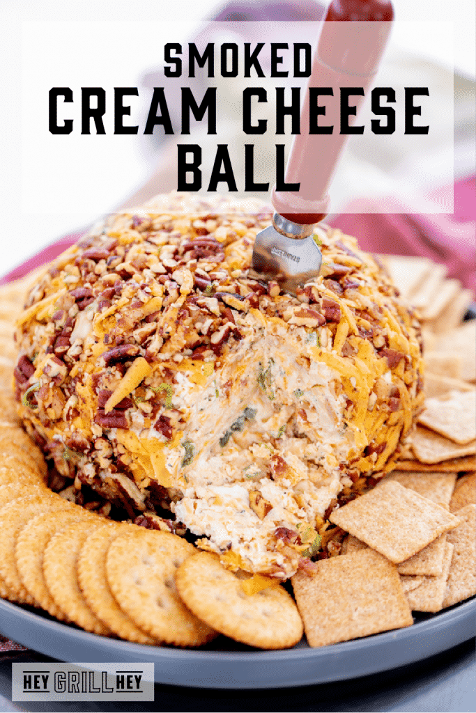 Smoked cream cheese ball surrounded by crackers with text overlay - Smoked Cream Cheese Ball.