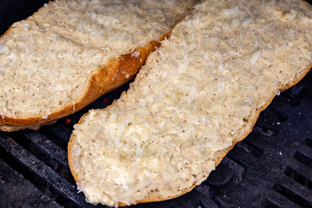 Garlic butter spread on a large loaf of bread sliced in half.