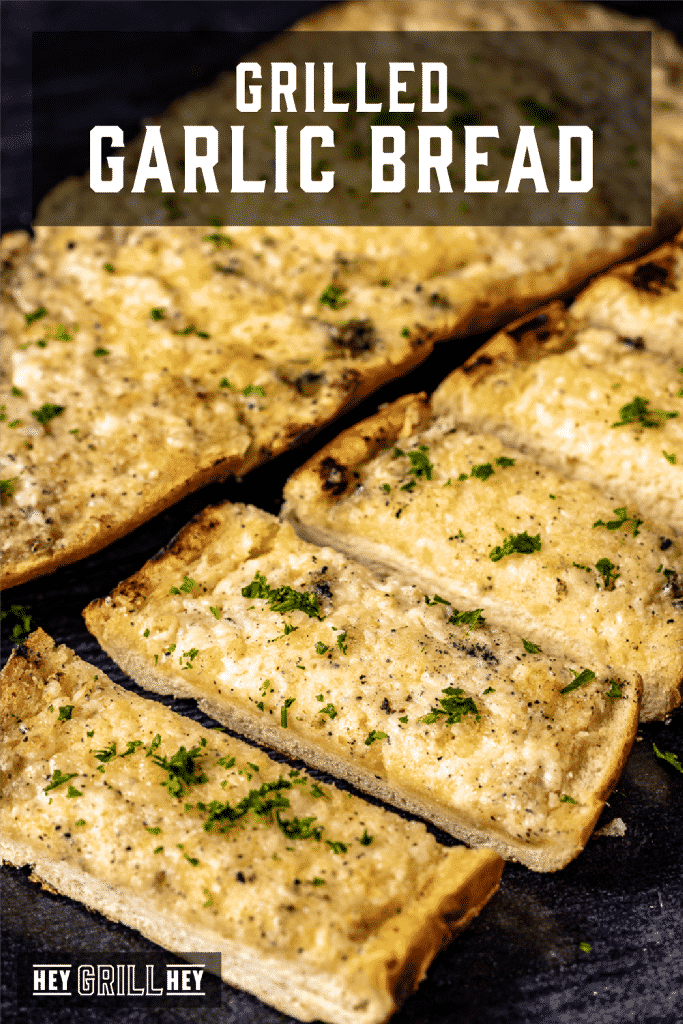 Sliced grilled garlic bread on a serving dish with text overlay - Grilled Garlic Bread.