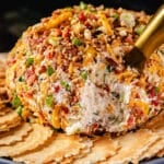 A cream cheese ball garnished with crackers.