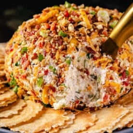 A cream cheese ball garnished with crackers.