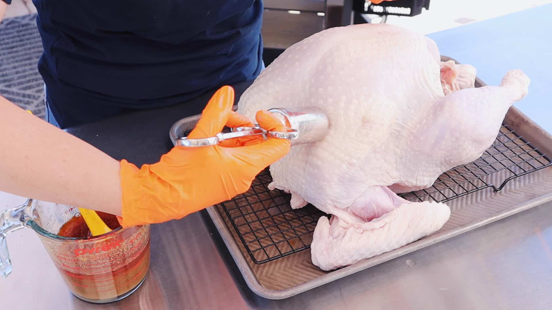 Turkey being injected with Cajun seasoning.