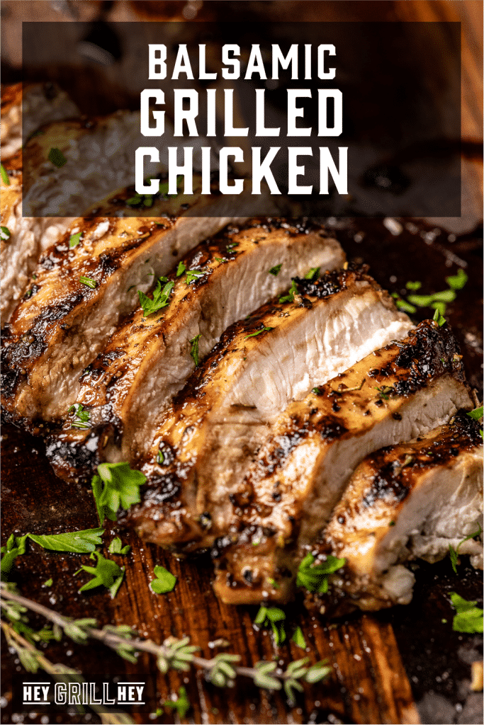 Sliced balsamic marinated chicken on a wooden cutting board with text overlay - Balsamic Grilled Chicken.