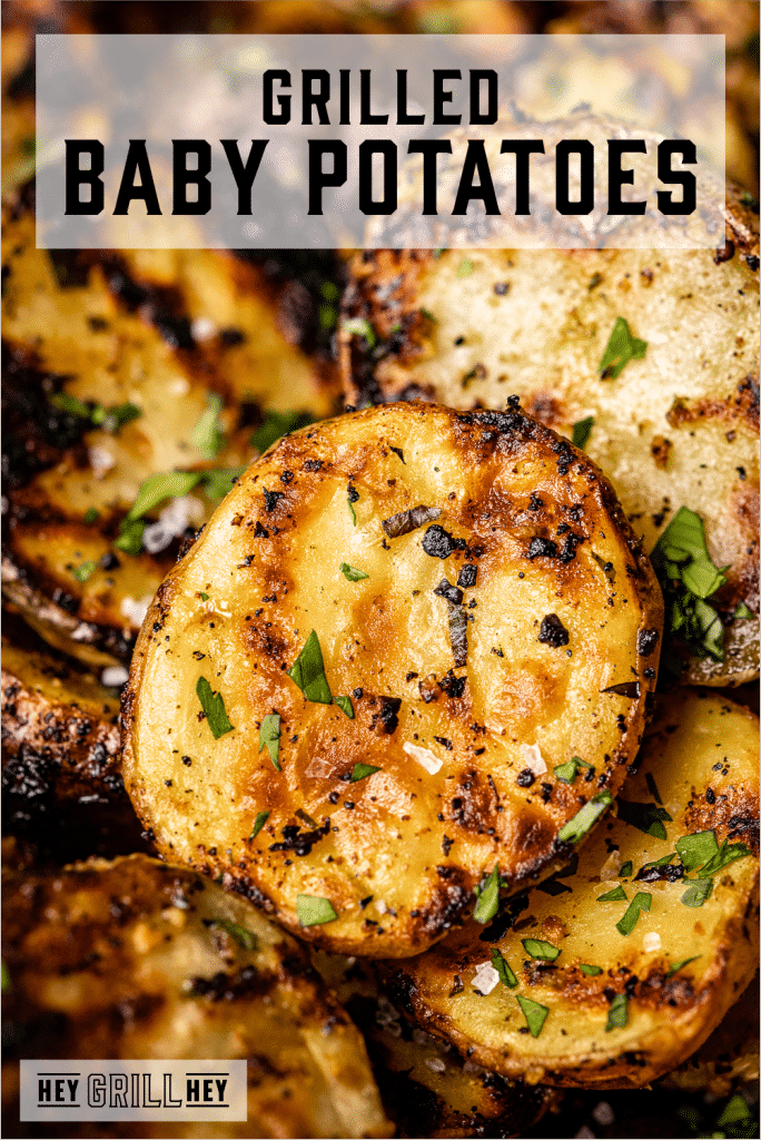 Seasoned and grilled baby potatoes with text overlay - Grilled Baby Potatoes.